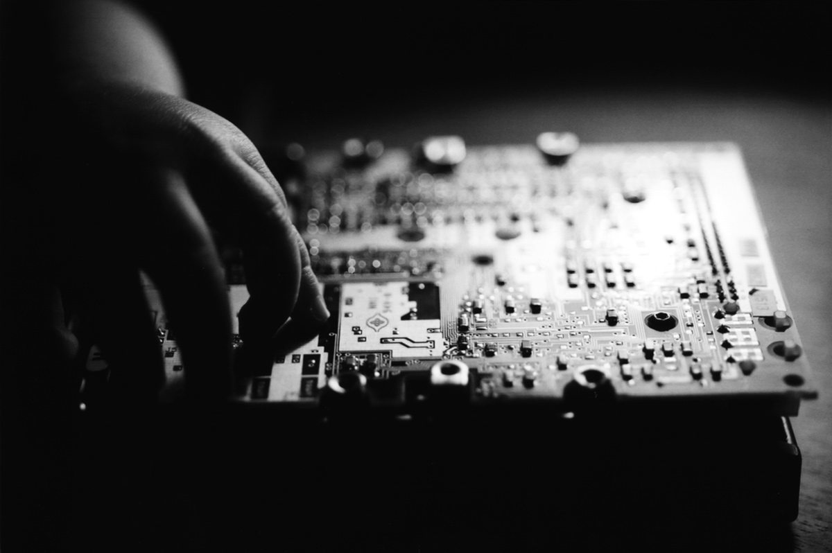 hand of child on circuit board